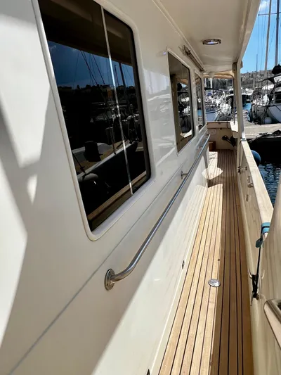  Yacht Photos Pics 1996 Fleming 55 yacht with teak deck, docked in marina.