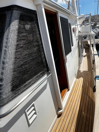  Yacht Photos Pics 1996 Fleming 55 yacht with teak deck and shaded windows in marina.