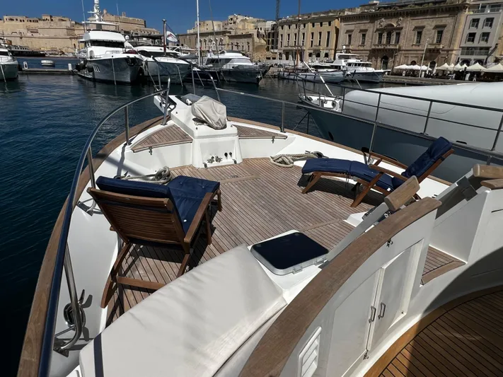  Yacht Photos Pics 1996 Fleming 55 yacht with deck chairs in a marina setting.