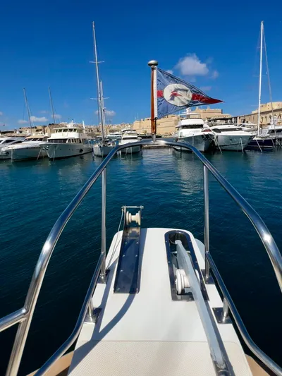  Yacht Photos Pics Bow view of a 1996 Fleming 55 yacht docked in a marina under clear blue skies.
