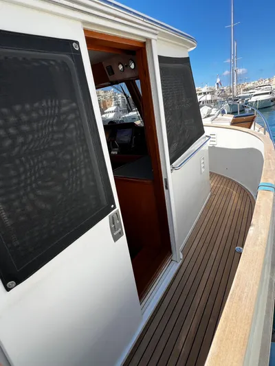  Yacht Photos Pics 1996 Fleming 55 yacht with open cabin door and wooden deck, docked at marina.