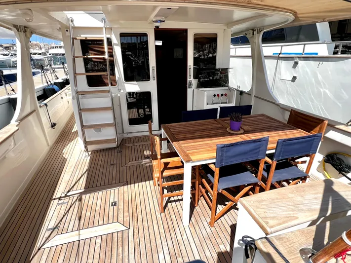  Yacht Photos Pics Spacious deck of 1996 Fleming 55 yacht with wooden table and chairs.