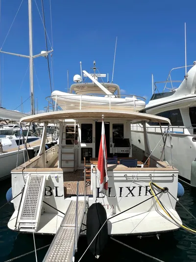  Yacht Photos Pics 1996 Fleming 55 yacht docked at marina, rear view with flag and clear blue sky.
