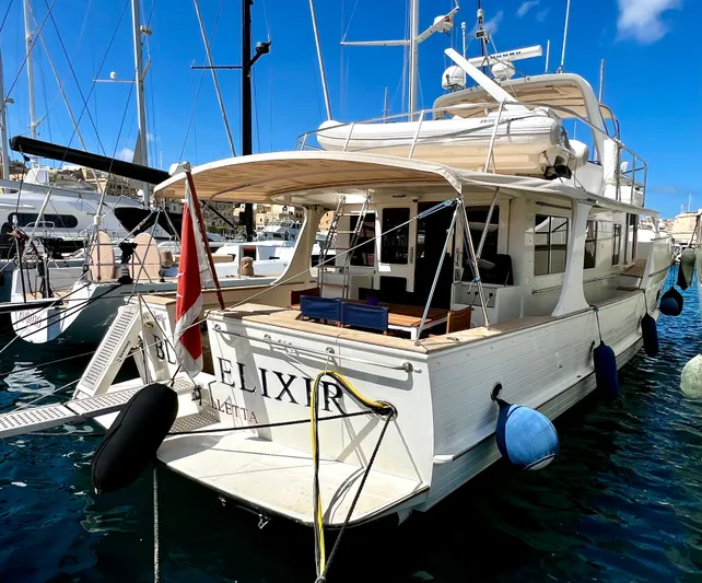  Yacht Photos Pics Luxury 1996 Fleming 55 yacht docked in marina, featuring elegant design and spacious deck.