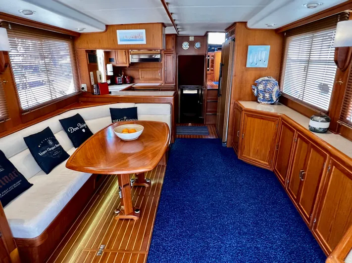  Yacht Photos Pics Luxurious interior of a 1996 Fleming 55 yacht with wooden furnishings and blue carpet.