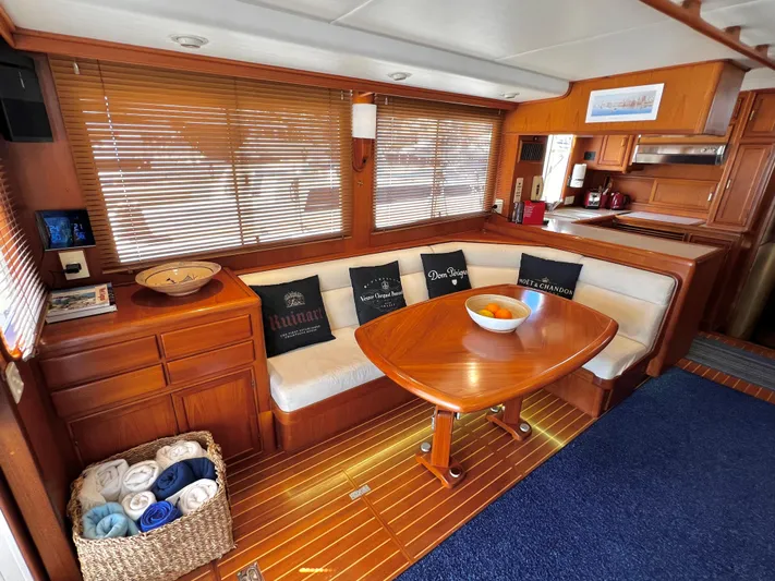  Yacht Photos Pics Luxurious 1996 Fleming 55 yacht interior with wooden dining area and cozy seating.