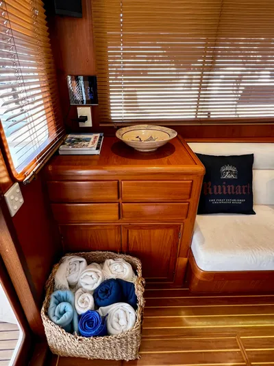  Yacht Photos Pics Interior of a 1996 Fleming 55 yacht with wooden cabinetry and rolled towels in a basket.