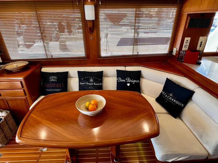  Yacht Photos Pics Luxurious interior of a 1996 Fleming 55 yacht with elegant wooden table and plush seating.
