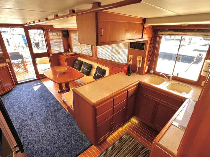  Yacht Photos Pics Luxurious 1996 Fleming 55 yacht interior with wooden cabinetry and cozy seating area.