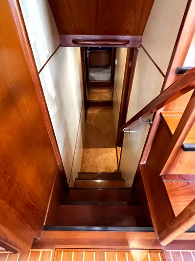  Yacht Photos Pics Staircase inside 1996 Fleming 55 yacht, featuring polished wood and elegant design.