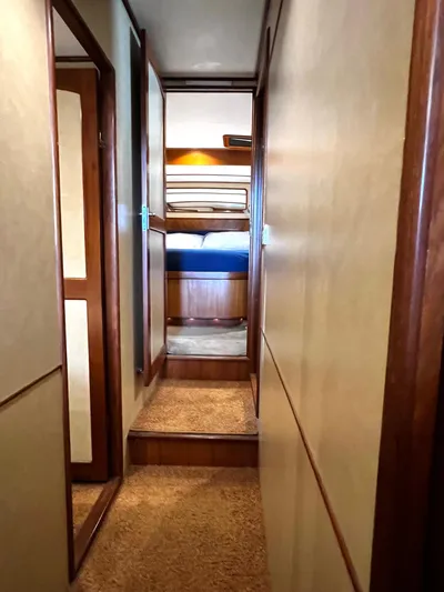  Yacht Photos Pics Hallway inside a 1996 Fleming 55 yacht, featuring wooden trim and carpeted steps.