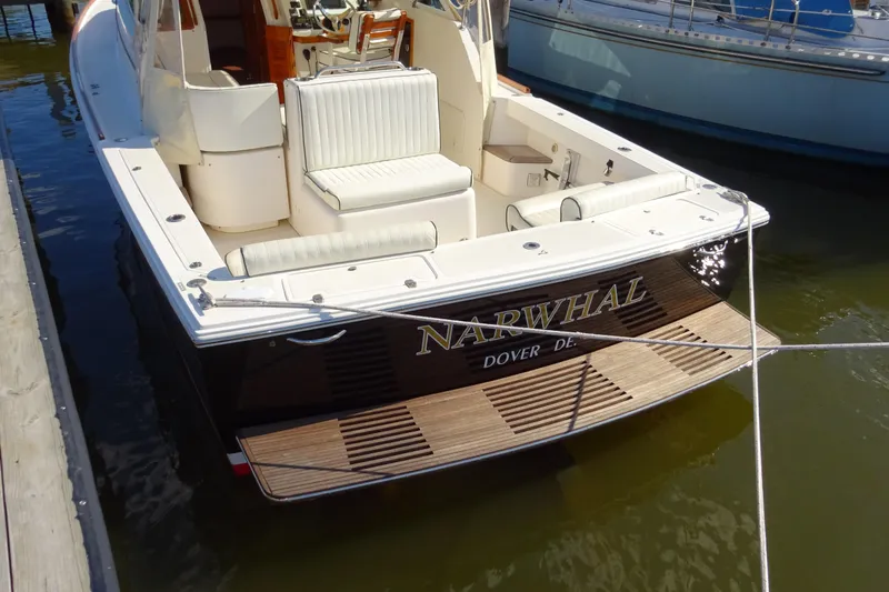 Narwhal Yacht Photos Pics 2007 Hunt Yachts Surfhunter 29 docked, featuring elegant seating and wooden deck.