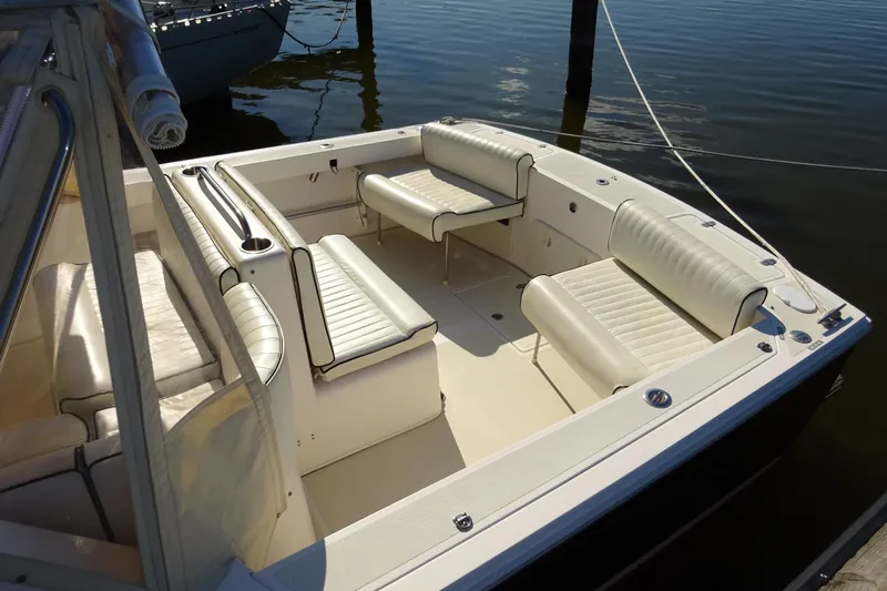 Narwhal Yacht Photos Pics 2007 Hunt Yachts Surfhunter 29 boat interior with white seating, docked on calm water.