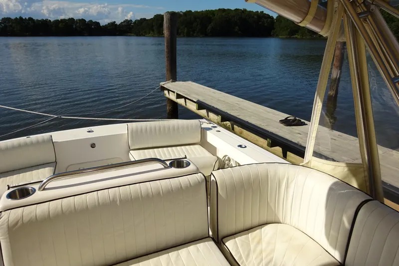 Narwhal Yacht Photos Pics Luxurious 2007 Hunt Yachts Surfhunter 29 with elegant seating by a serene dockside.