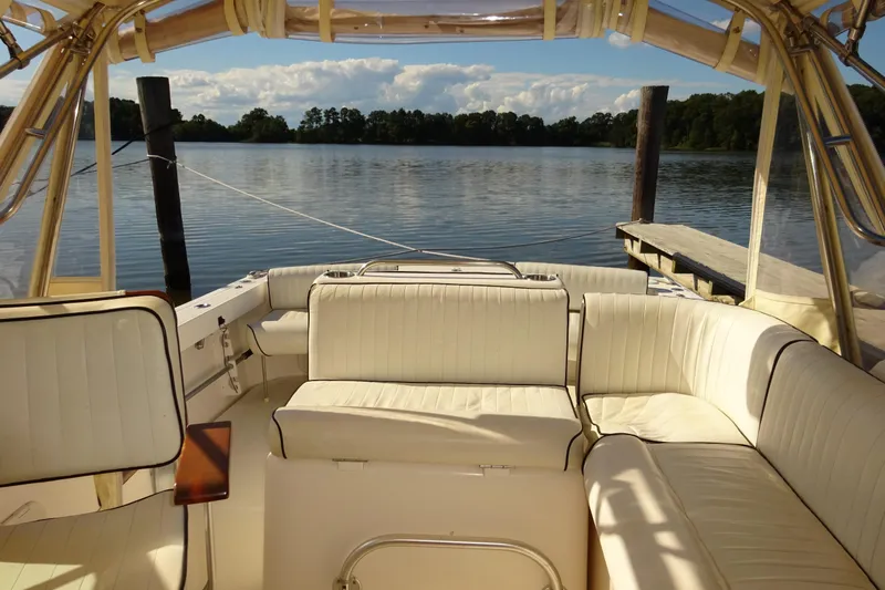Narwhal Yacht Photos Pics Luxurious interior of 2007 Hunt Yachts Surfhunter 29, docked by serene waters.