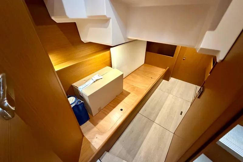  Yacht Photos Pics 2026 Beneteau Swift Trawler 41 Fly interior storage area with wooden finish.