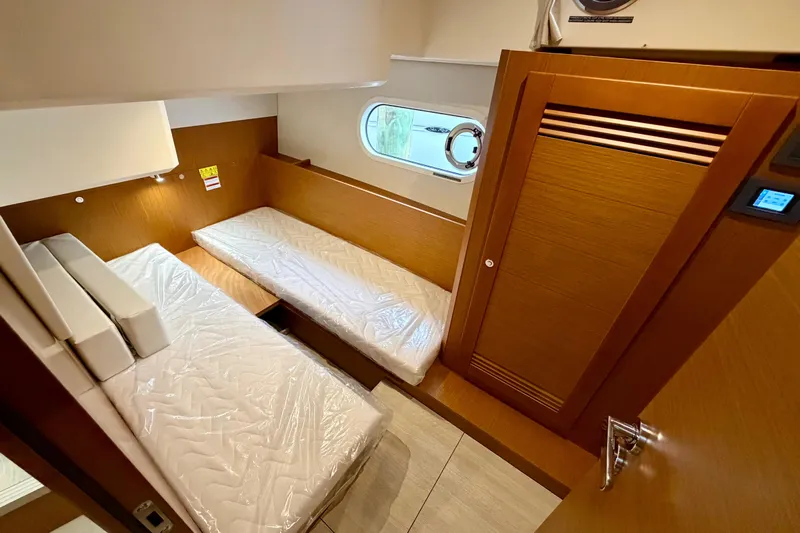  Yacht Photos Pics 2026 Beneteau Swift Trawler 41 Fly cabin with twin beds and wooden interior.