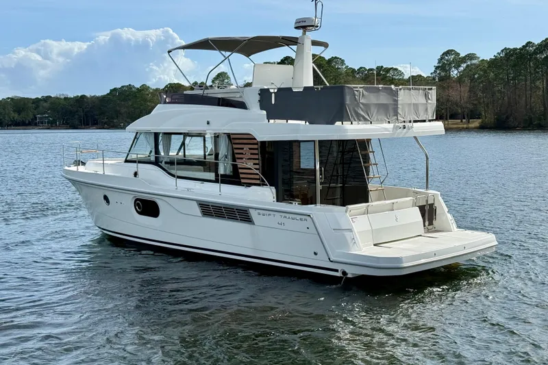  Yacht Photos Pics 2026 Beneteau Swift Trawler 41 Fly on serene lake with lush background.