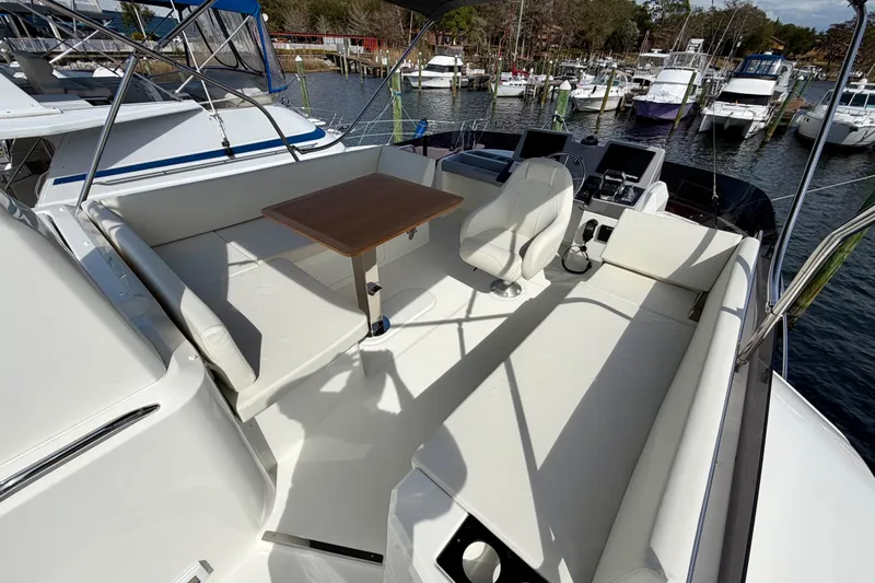  Yacht Photos Pics 2026 Beneteau Swift Trawler 41 Flybridge with seating and table, docked in marina.