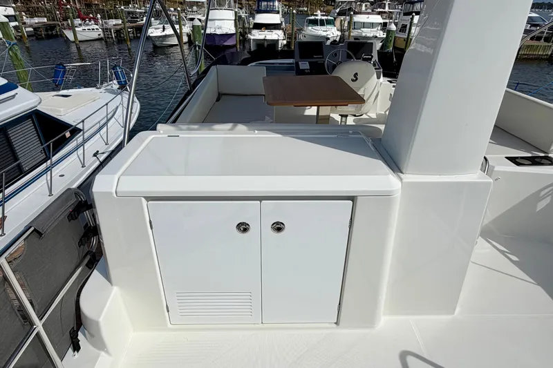  Yacht Photos Pics 2026 Beneteau Swift Trawler 41 Fly deck with seating and helm, docked at marina.