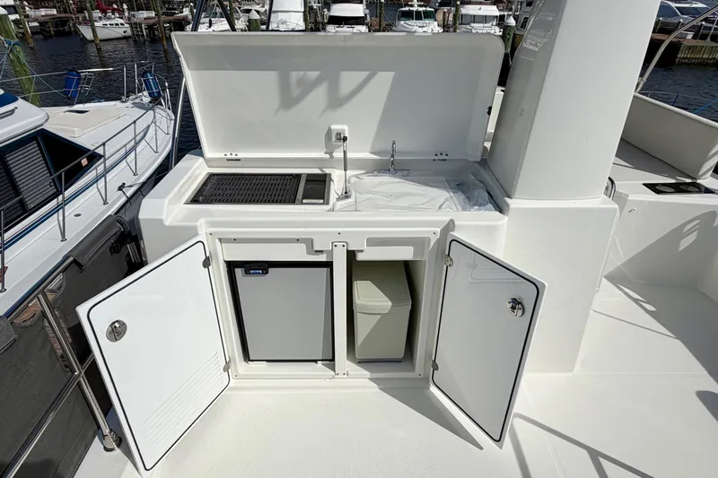  Yacht Photos Pics Outdoor kitchenette on 2026 Beneteau Swift Trawler 41 Fly, featuring grill and storage.