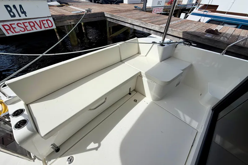  Yacht Photos Pics 2026 Beneteau Swift Trawler 41 Fly, spacious deck seating area at marina.
