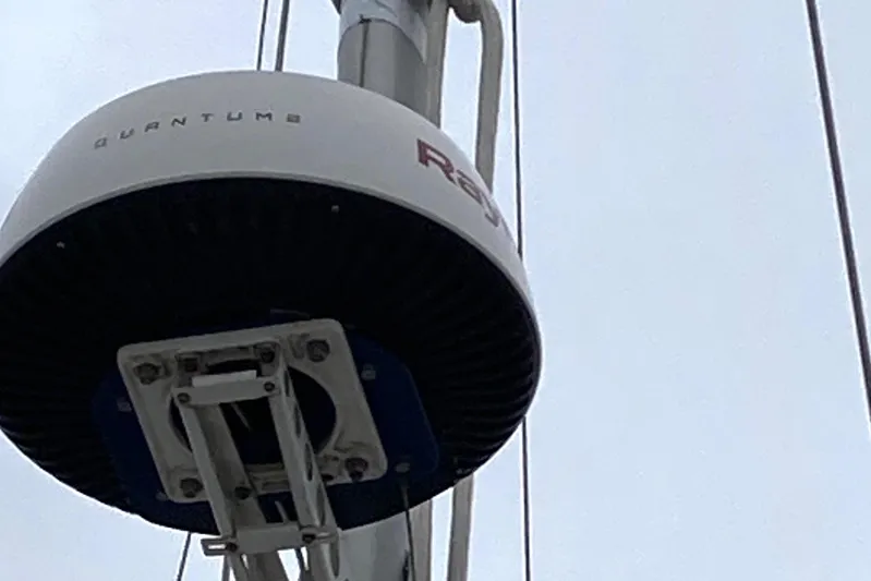 Latte Yacht Photos Pics Radar equipment on 1987 Nauticat 38 sailboat mast against cloudy sky.