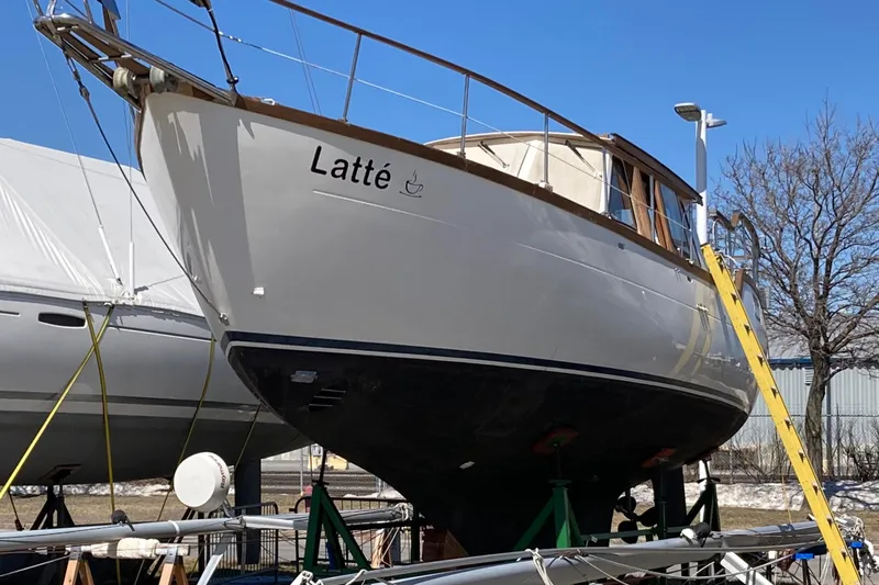 Latte Yacht Photos Pics 1987 Nauticat 38 sailboat named "Latt&eacute;" on dry dock with clear blue sky.