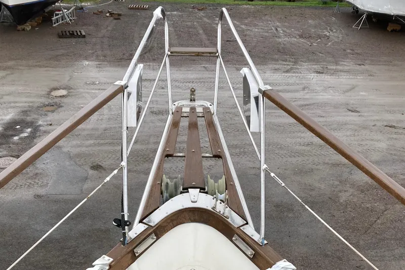 Latte Yacht Photos Pics Bow view of 1987 Nauticat 38 sailboat on dry dock, showcasing deck and railings.
