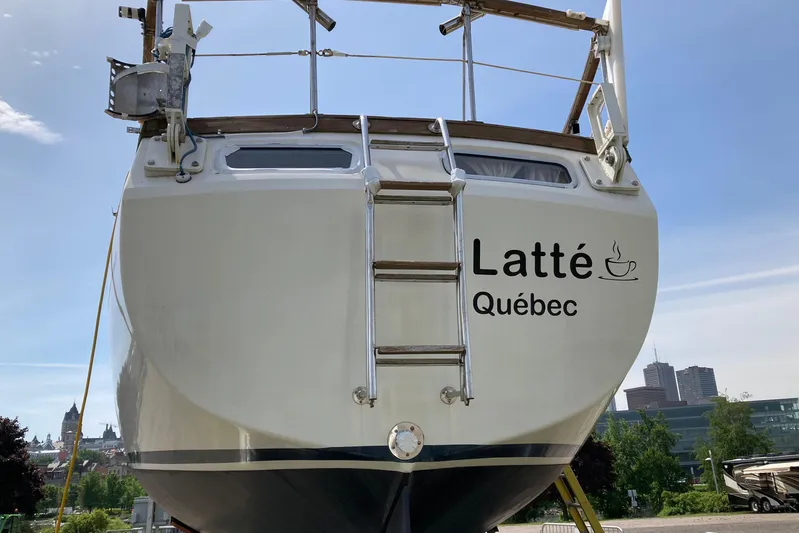 Latte Yacht Photos Pics 1987 Nauticat 38 sailboat named "Latt&eacute; Qu&eacute;bec" with cityscape background.