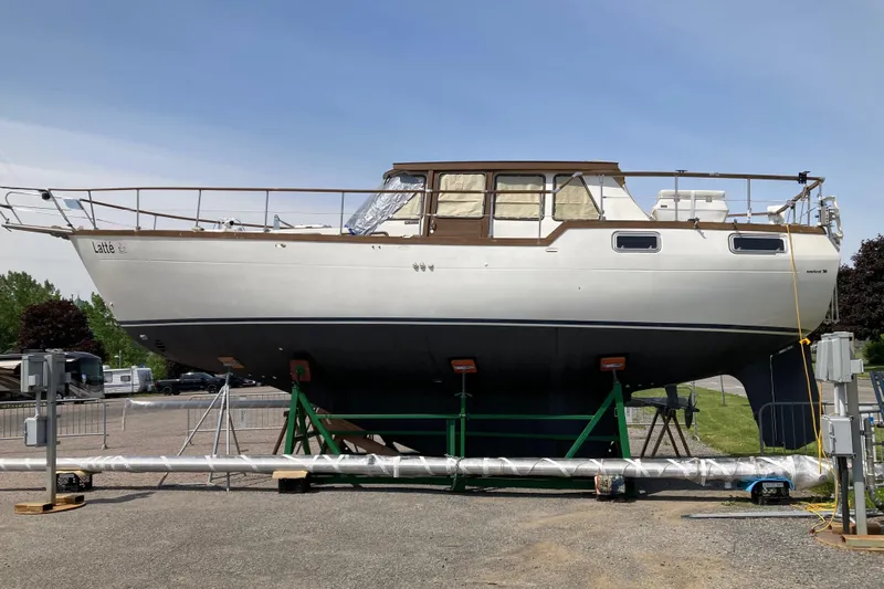 Latte Yacht Photos Pics 1987 Nauticat 38 sailboat on land, supported by stands, under clear blue sky.