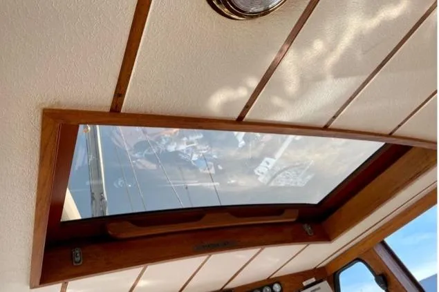 Latte Yacht Photos Pics Interior view of 1987 Nauticat 38 sailboat with wooden ceiling and skylight.