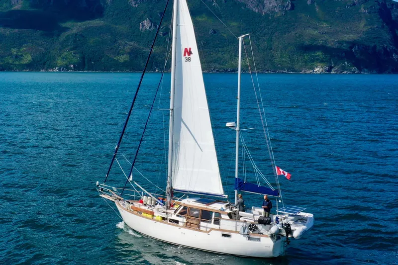 Latte Yacht Photos Pics Sailing yacht Nauticat 38, 1987 model, cruising on a scenic blue ocean.