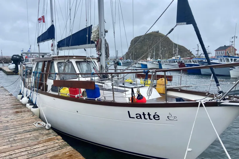 Latte Yacht Photos Pics 1987 Nauticat 38 sailboat "Latt&eacute;" docked in a marina on a cloudy day.