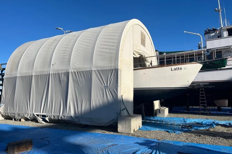 Latte Yacht Photos Pics 1987 Nauticat 38 sailboat "Latt&eacute;" in covered dry dock, clear blue sky.