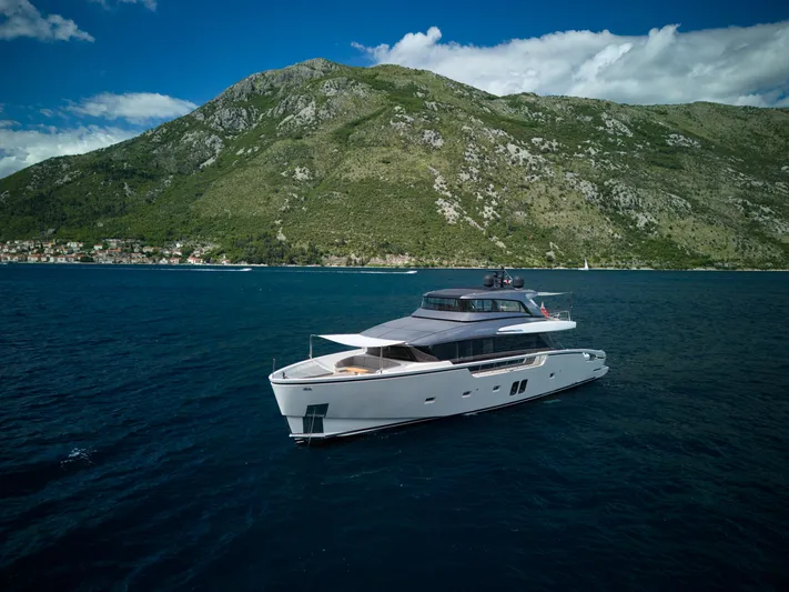  Yacht Photos Pics Luxurious 2020 Sanlorenzo SX88 yacht cruising near scenic coastal mountains.