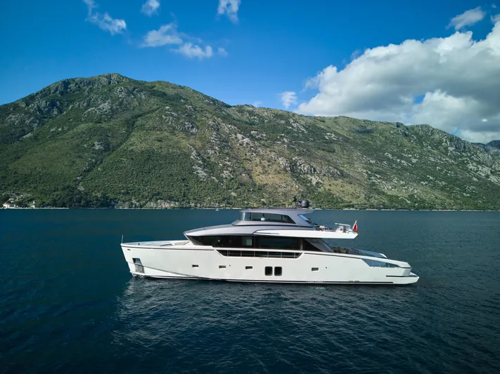  Yacht Photos Pics Luxury Sanlorenzo SX88 yacht cruising near scenic mountains, 2020 model.