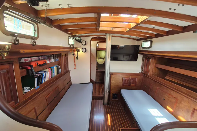 Pearl Yacht Photos Pics Interior of 1996 Cape George 36 sailboat with wooden finishes and cozy seating.