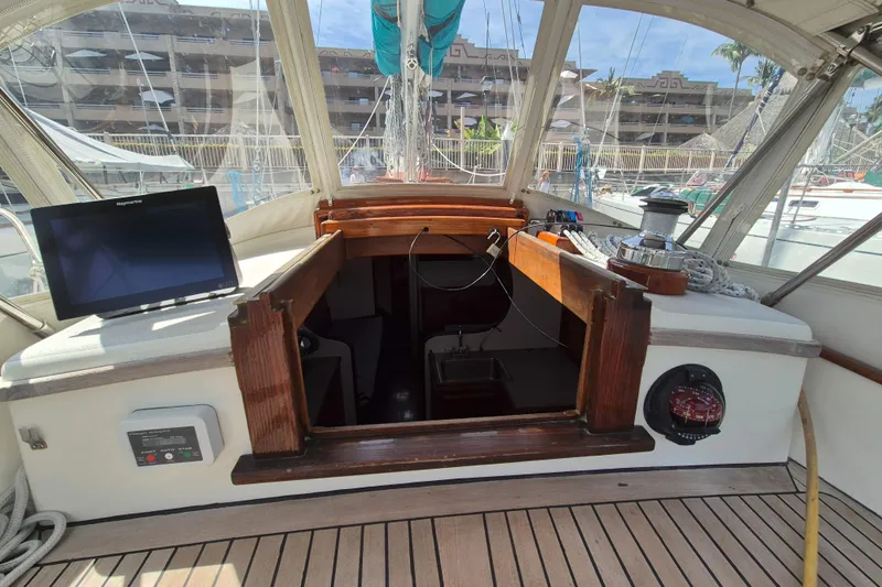 Pearl Yacht Photos Pics Cockpit of a 1996 Cape George 36 sailboat with navigation equipment and wooden finish.