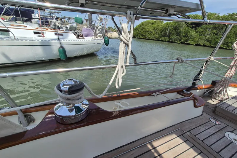 Pearl Yacht Photos Pics Sailboat deck view of a 1996 Cape George 36, docked near lush greenery.