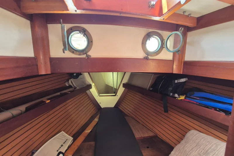 Pearl Yacht Photos Pics Interior of 1996 Cape George 36 sailboat with wooden paneling and portholes.