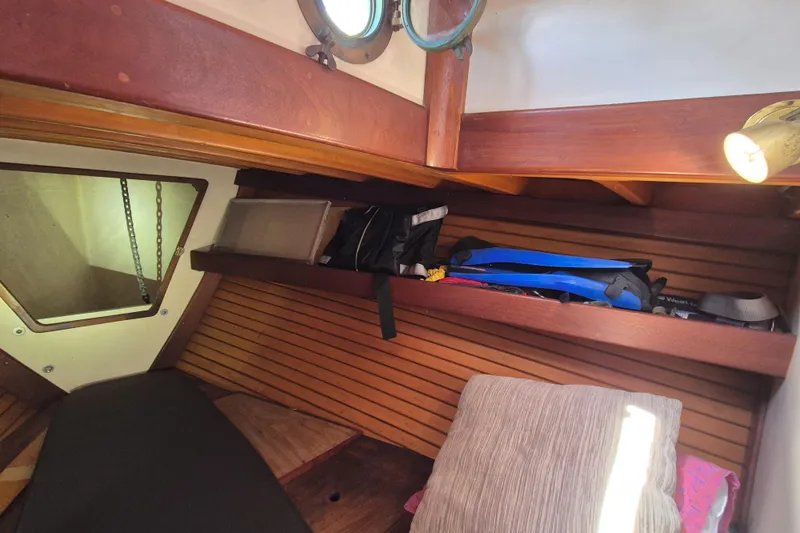 Pearl Yacht Photos Pics Cozy interior cabin of 1996 Cape George 36 sailboat with wooden accents and storage.