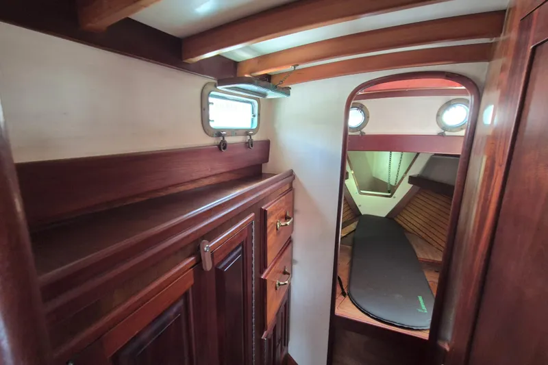 Pearl Yacht Photos Pics Interior of 1996 Cape George 36 sailboat with wooden cabinetry and cozy sleeping area.