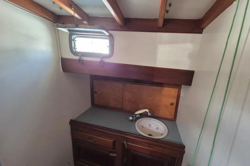 Pearl Yacht Photos Pics Interior of 1996 Cape George 36 sailboat with wooden cabinetry and small sink.