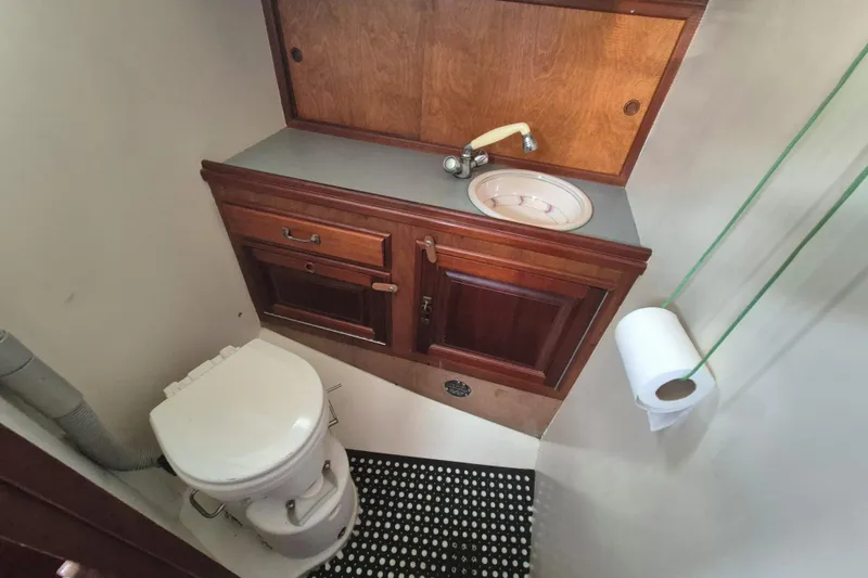 Pearl Yacht Photos Pics 1996 Cape George 36 yacht bathroom with wooden cabinetry and compact sink.