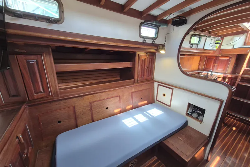 Pearl Yacht Photos Pics Interior of 1996 Cape George 36 sailboat with wooden cabinetry and cozy seating area.