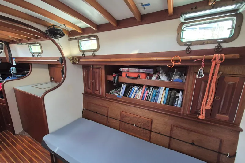 Pearl Yacht Photos Pics Interior of a 1996 Cape George 36 sailboat with wooden cabinetry and bookshelves.