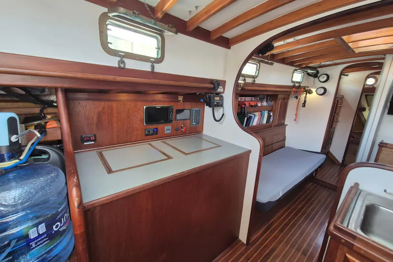 Pearl Yacht Photos Pics Interior of a 1996 Cape George 36 sailboat with wooden cabinetry and navigation equipment.