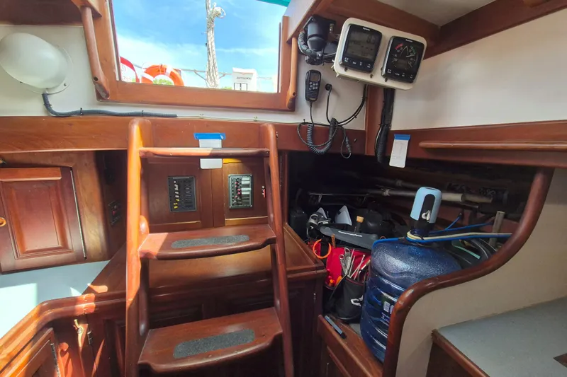 Pearl Yacht Photos Pics Interior of a 1996 Cape George 36 sailboat with wooden steps and navigation equipment.