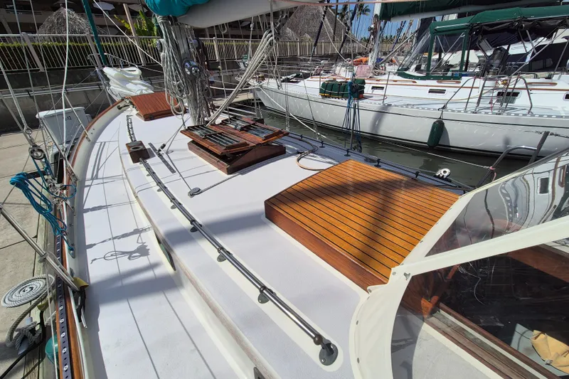 Pearl Yacht Photos Pics Cape George 36 sailboat deck, 1996 model, docked with wooden accents and rigging.